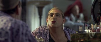 Movie still from “Little Children” (2006), directed by Todd Field – A man in a purple shirt and a purple and white scarf; Close Up shot, Over the shoulder angle