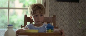 Movie still from “Little Children” (2006), directed by Todd Field – A boy sitting at a table with a bowl in front of him; Close Up shot, Over the shoulder angle