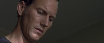 Movie still from “Little Children” (2006), directed by Todd Field – A man's face in a dark room; Close Up shot, Low angle