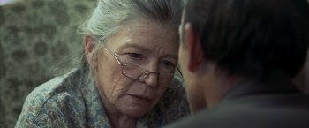 Movie still from “Little Children” (2006), directed by Todd Field – An older woman wearing glasses looking at a younger man; Close Up shot, Over the shoulder angle