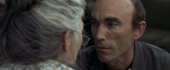 Movie still from “Little Children” (2006), directed by Todd Field – An older man looking into the mirror of a younger man; Close Up shot, Over the shoulder angle