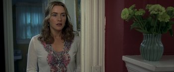 Movie still from “Little Children” (2006), directed by Todd Field – A woman standing in front of a door looking at the camera; Close Up shot, Over the shoulder angle