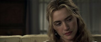 Movie still from “Little Children” (2006), directed by Todd Field – A person sitting on a couch; Close Up shot, Over the shoulder angle