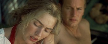 Movie still from “Little Children” (2006), directed by Todd Field – A man and a woman laying on a bed together; Close Up shot, High angle