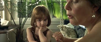 Movie still from “Little Children” (2006), directed by Todd Field – A little girl sitting next to an older woman; Close Up shot, Over the shoulder angle