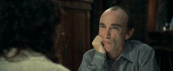 Movie still from “Little Children” (2006), directed by Todd Field – A person with his hand on his chin; Close Up shot, Over the shoulder angle