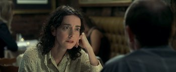 Movie still from “Little Children” (2006), directed by Todd Field – A woman sitting in front of a man in a chair; Close Up shot, Over the shoulder angle