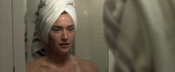 Movie still from “Little Children” (2006), directed by Todd Field – A woman with a towel wrapped around her head looking into a mirror; Close Up shot, Over the shoulder angle