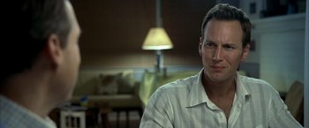 Movie still from “Little Children” (2006), directed by Todd Field – A person sitting in front of a lamp; Close Up shot, Over the shoulder angle