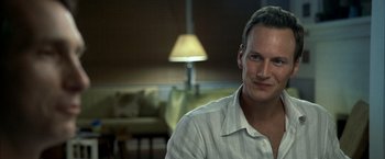 Movie still from “Little Children” (2006), directed by Todd Field – A person sitting in a living room; Close Up shot, Over the shoulder angle