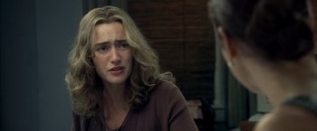 Movie still from “Little Children” (2006), directed by Todd Field – A person sitting in a room; Close Up shot, Over the shoulder angle