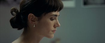 Movie still from “Little Children” (2006), directed by Todd Field – A person wearing a earring; Close Up shot, Over the shoulder angle