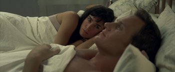 Movie still from “Little Children” (2006), directed by Todd Field – A man and a woman laying in a bed together; Close Up shot, High angle