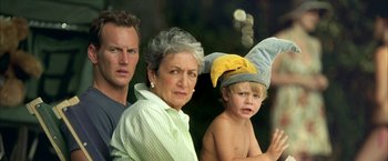 Movie still from “Little Children” (2006), directed by Todd Field – An older woman and two young boys are standing together; Close Up shot, High angle