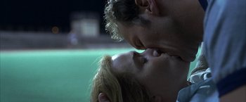 Movie still from “Little Children” (2006), directed by Todd Field – A man and a woman kissing in front of a swimming pool; Close Up shot, Low angle
