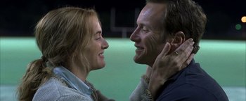 Movie still from “Little Children” (2006), directed by Todd Field – A man and a woman smiling at each other; Close Up shot, High angle