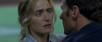 Movie still from “Little Children” (2006), directed by Todd Field – A woman and a man face each other in front of each other; Close Up shot, Over the shoulder angle