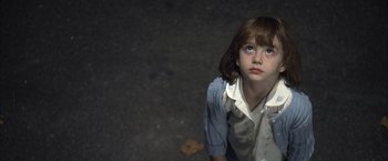 Movie still from “Little Children” (2006), directed by Todd Field – A young girl is looking up at the camera; Close Up shot, High angle