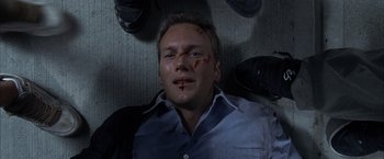 Movie still from “Little Children” (2006), directed by Todd Field – A person laying on the ground with blood on his face; Close Up shot, Overhead angle