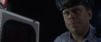 Movie still from “Little Children” (2006), directed by Todd Field – A police officer in uniform is looking at the camera; Close Up shot, Low angle