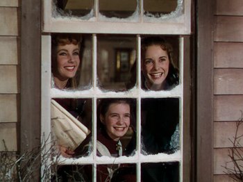 Movie still from “Little Women” (1949), directed by Mervyn LeRoy – Three women looking through a window with snow on them; Medium shot, Low angle