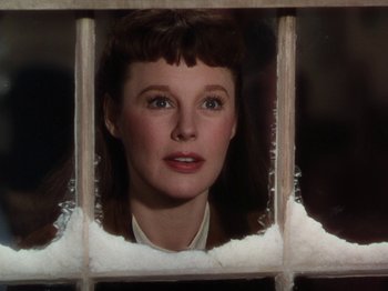 Movie still from “Little Women” (1949), directed by Mervyn LeRoy – A woman looking through a window with snow on the ground; Close Up shot, Low angle