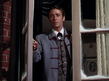 Movie still from “Little Women” (1949), directed by Mervyn LeRoy – A man in a suit standing in front of a window holding a cigarette; Close Up shot, Low angle
