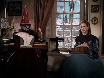 Movie still from “Little Women” (1949), directed by Mervyn LeRoy – Two women dressed up in costumes in a living room; Medium shot, Over the shoulder angle