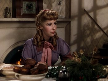 Movie still from “Little Women” (1949), directed by Mervyn LeRoy – A woman sitting at a table with a bowl of food; Medium shot, Over the shoulder angle