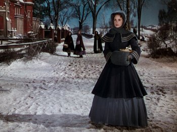 Movie still from “Little Women” (1949), directed by Mervyn LeRoy – A woman dressed in a long black coat and a long black skirt; Medium shot, Low angle