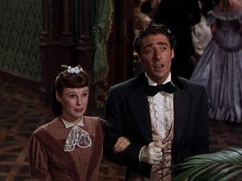 Movie still from “Little Women” (1949), directed by Mervyn LeRoy – A man and a woman standing next to each other; Medium shot, Low angle