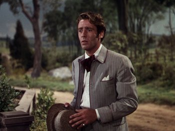 Movie still from “Little Women” (1949), directed by Mervyn LeRoy – A man in a suit and tie holding a hat; Close Up shot, Over the shoulder angle