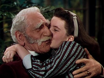 Movie still from “Little Women” (1949), directed by Mervyn LeRoy – An old man and a young girl are kissing; Close Up shot, High angle