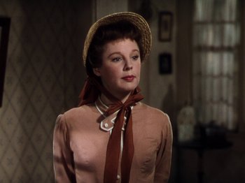 Movie still from “Little Women” (1949), directed by Mervyn LeRoy – A woman wearing a straw hat and a pink blouse; Close Up shot, Low angle