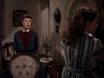 Movie still from “Little Women” (1949), directed by Mervyn LeRoy – Two women are standing in front of a mirror; Medium shot, Over the shoulder angle