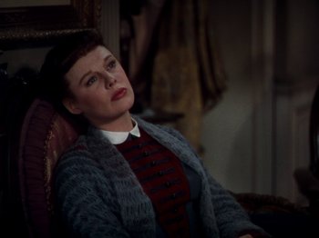 Movie still from “Little Women” (1949), directed by Mervyn LeRoy – A woman sitting in a chair with her eyes closed; Medium shot, High angle