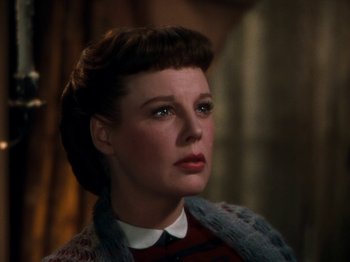 Movie still from “Little Women” (1949), directed by Mervyn LeRoy – A woman in a red sweater looking to her left; Close Up shot, Low angle