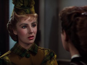 Movie still from “Little Women” (1949), directed by Mervyn LeRoy – A woman wearing a hat and a plaid dress; Close Up shot, Over the shoulder angle