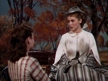Movie still from “Little Women” (1949), directed by Mervyn LeRoy – Two women sitting on a park bench talking to each other; Medium shot, Over the shoulder angle