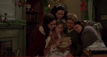 Movie still from “Little Women” (1994), directed by Gillian Armstrong – A group of people looking at a piece of paper; Medium shot, High angle