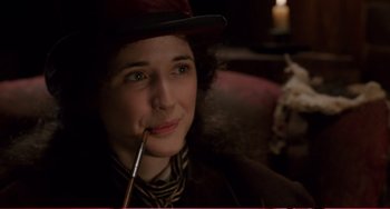 Movie still from “Little Women” (1994), directed by Gillian Armstrong – A woman with a pipe in her mouth and wearing a hat; Close Up shot, High angle
