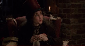 Movie still from “Little Women” (1994), directed by Gillian Armstrong – A woman sitting on a couch with a candle in the background; Close Up shot, High angle