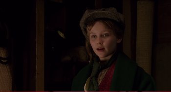 Movie still from “Little Women” (1994), directed by Gillian Armstrong – A young girl wearing a green coat and a hat; Close Up shot, Over the shoulder angle