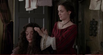 Movie still from “Little Women” (1994), directed by Gillian Armstrong – A young woman cutting another young woman's hair; Medium shot, Over the shoulder angle