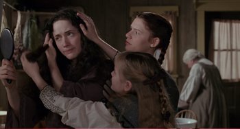 Movie still from “Little Women” (1994), directed by Gillian Armstrong – A group of people that are sitting around a table; Medium shot, Over the shoulder angle