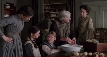 Movie still from “Little Women” (1994), directed by Gillian Armstrong – An old woman and a group of young girls in a kitchen; Medium shot, High angle