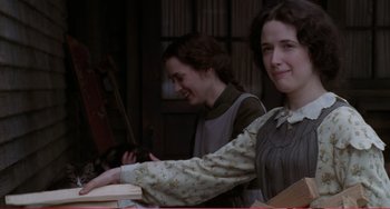 Movie still from “Little Women” (1994), directed by Gillian Armstrong – Two young women sitting at a table with a violin; Medium shot, Low angle