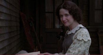 Movie still from “Little Women” (1994), directed by Gillian Armstrong – A young woman sitting in front of an instrument; Medium shot, Over the shoulder angle