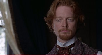 Movie still from “Little Women” (1994), directed by Gillian Armstrong – A person wearing a suit and tie; Close Up shot, Over the shoulder angle