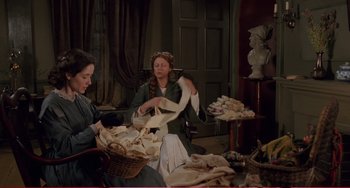 Movie still from “Little Women” (1994), directed by Gillian Armstrong – Two women are working in a room filled with various items; Medium shot, High angle